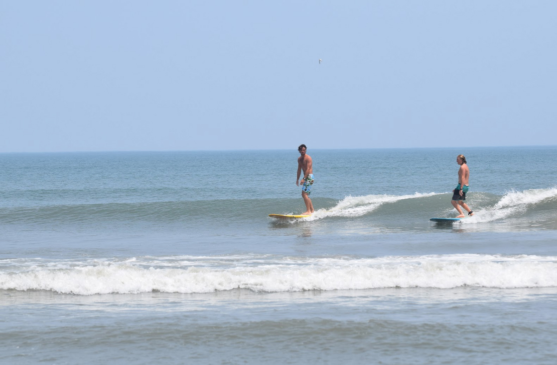 surfers on the 4x4 beach
