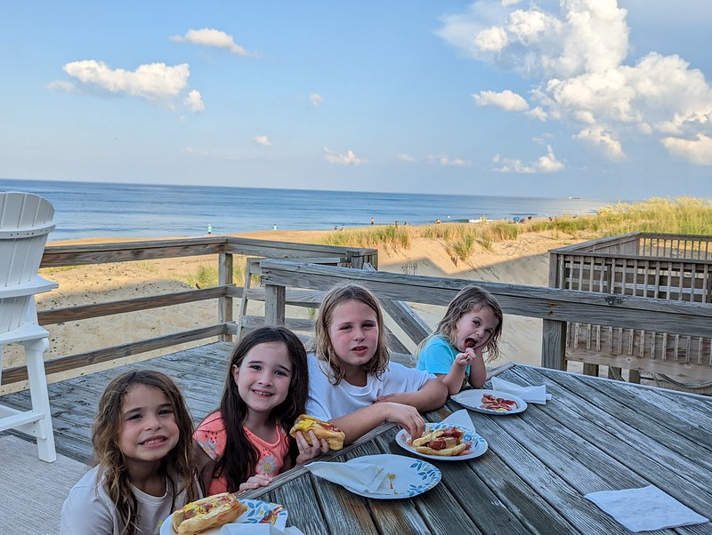Kids eating hot dogs on the deck